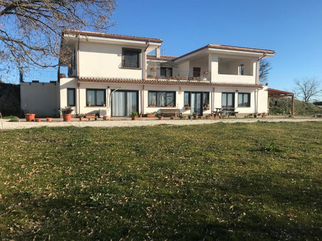 a large house with a lawn in front of it at B&B Il tramonto in Barbarano Romano