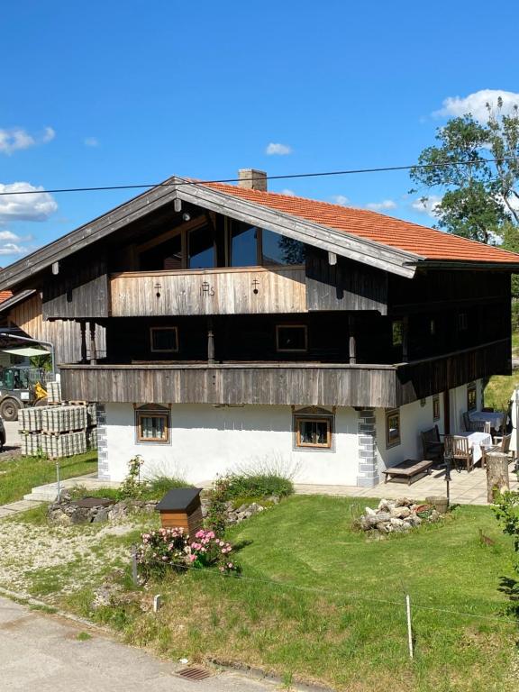 a house with a wooden roof on top of it at Ferienhaus Tölzer Land in Bad Tölz