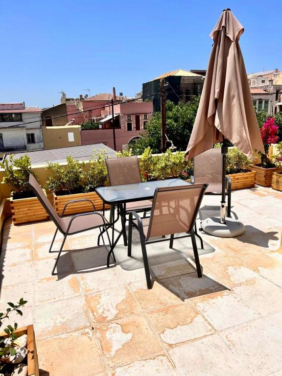 stół, krzesła i parasol na patio w obiekcie Canevaro Twins (North) w Chanii