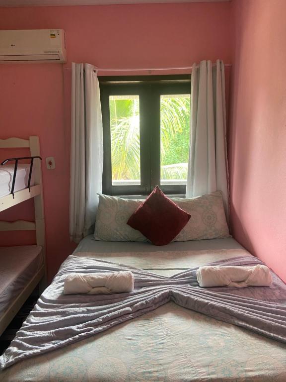 a bed in a room with a window at Casa YeS Jeri in Jericoacoara