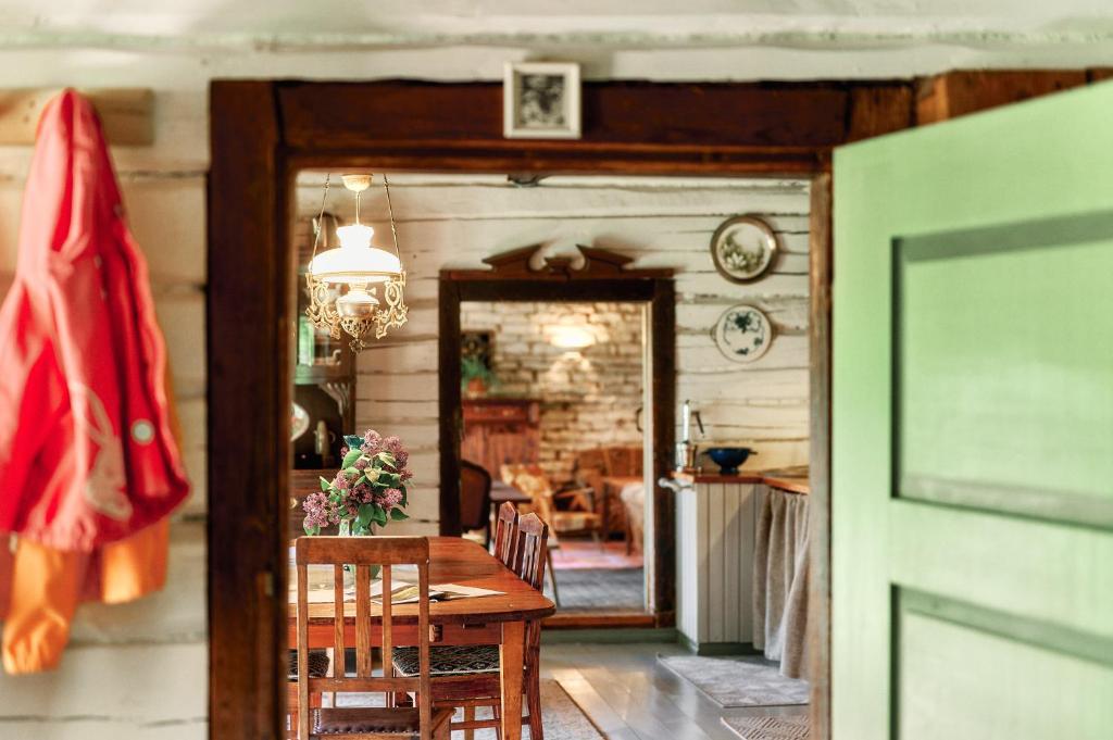 a dining room with a wooden table and a mirror at Matsi cottage in Igaküla