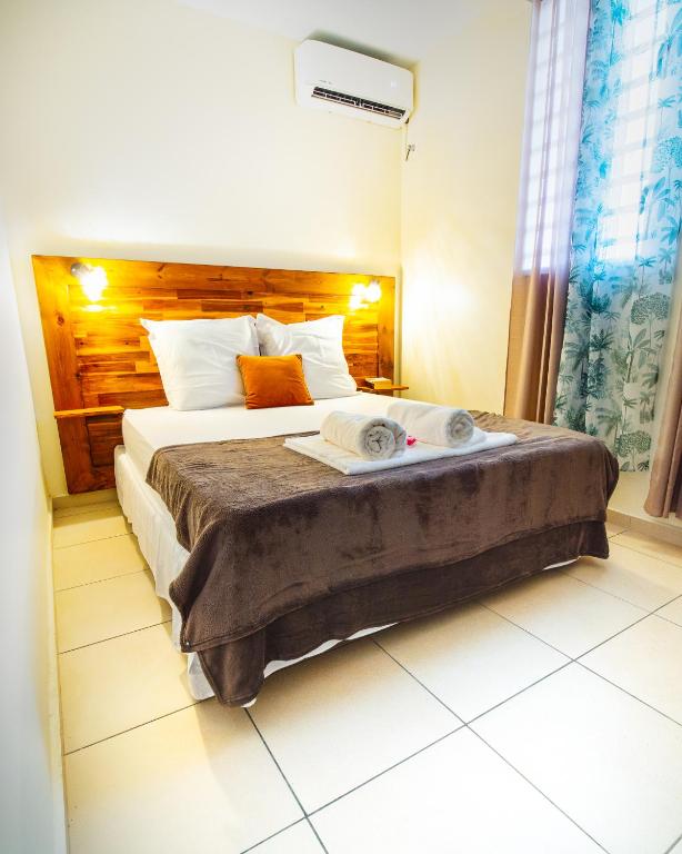 a bedroom with a large bed in a room at T2 jacuzzis et piscine au centre ville de Port-Louis in Port-Louis
