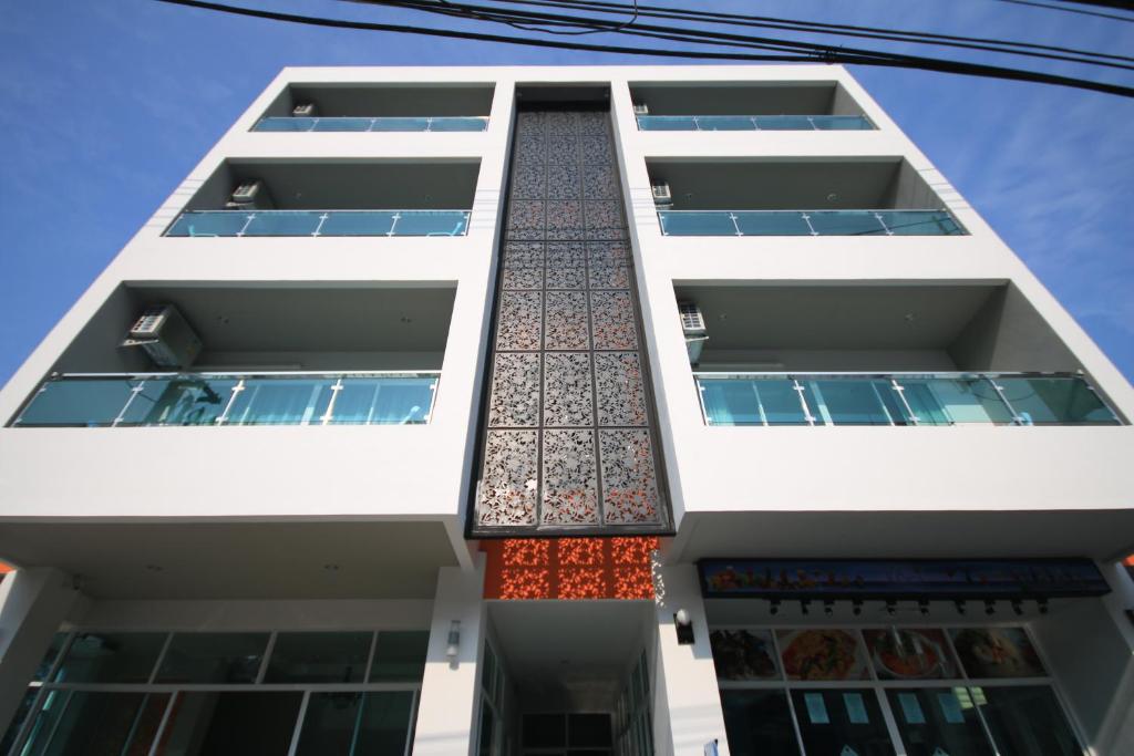 a white building with tiles on the side of it at Karon Sea Side in Karon Beach