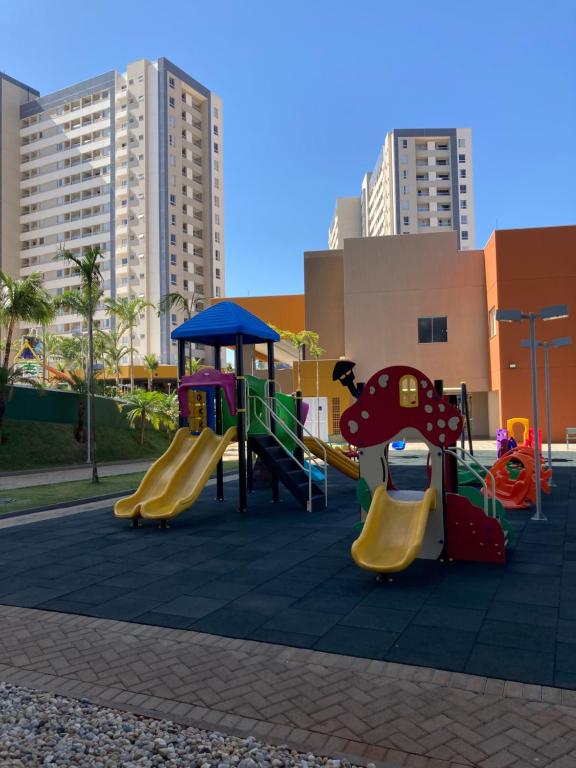 a playground with a slide in a city at Apartamento Solar das Águas Park Resort in Olímpia