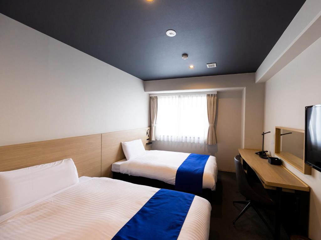 Postel nebo postele na pokoji v ubytování Ariston Hotel Kyoto Jujo