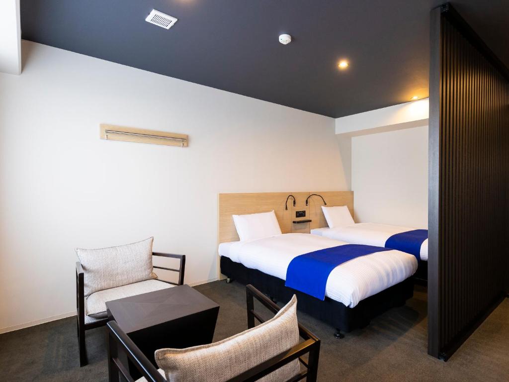 Postel nebo postele na pokoji v ubytování Ariston Hotel Kyoto Jujo