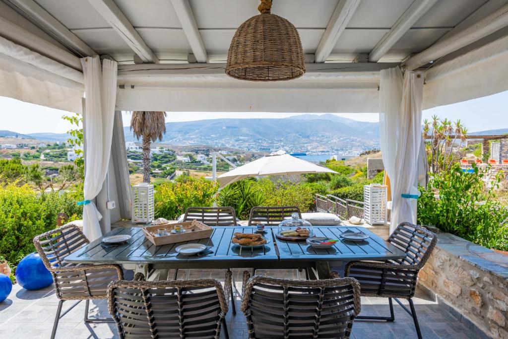a blue table and chairs on a patio with a view at Panorama Maisonette in Livadia