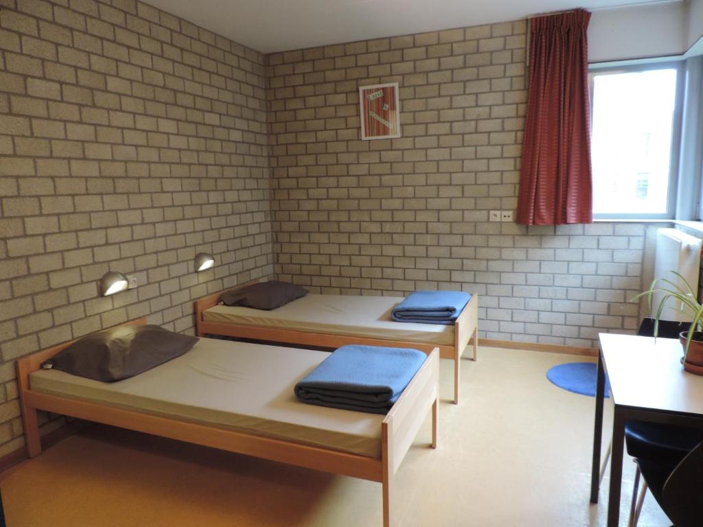 Postel nebo postele na pokoji v ubytování Hostel Blauwput Leuven