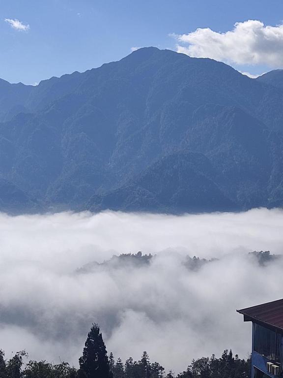 a view of a mountain with clouds in the valley at Pi’s Boutique Sapa in Sapa