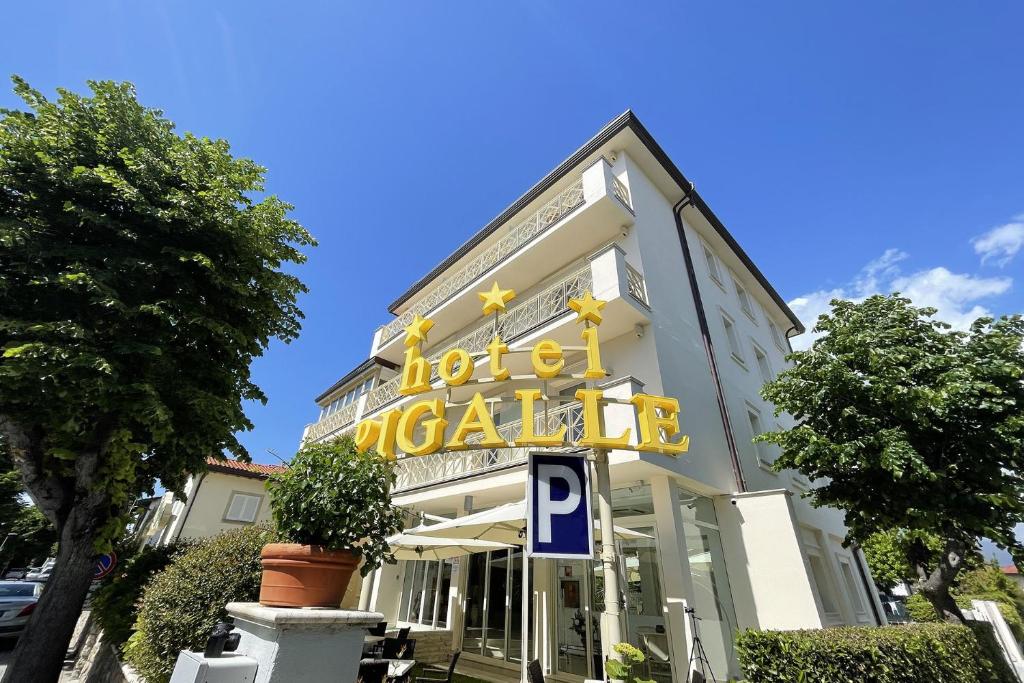 a building with a sign on the front of it at HOTEL PIGALLE in Forte dei Marmi