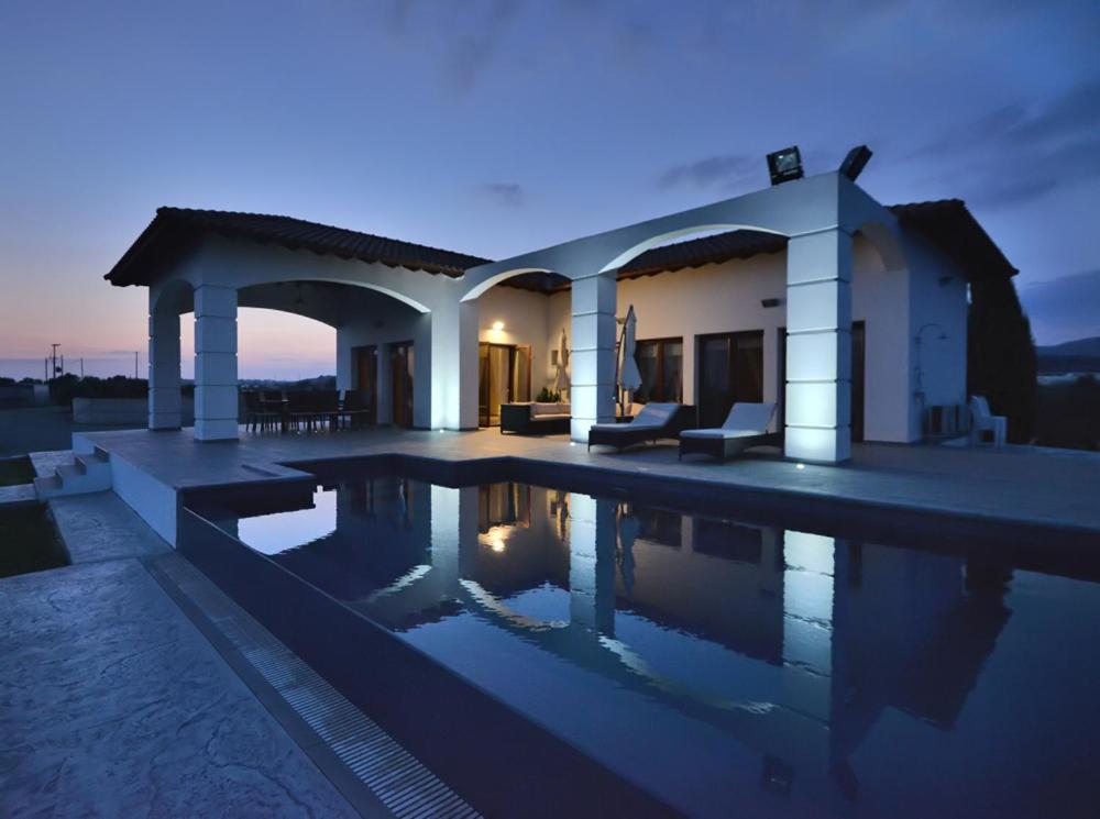 a villa with a swimming pool at night at Villa Olivo Maroni in Maroni