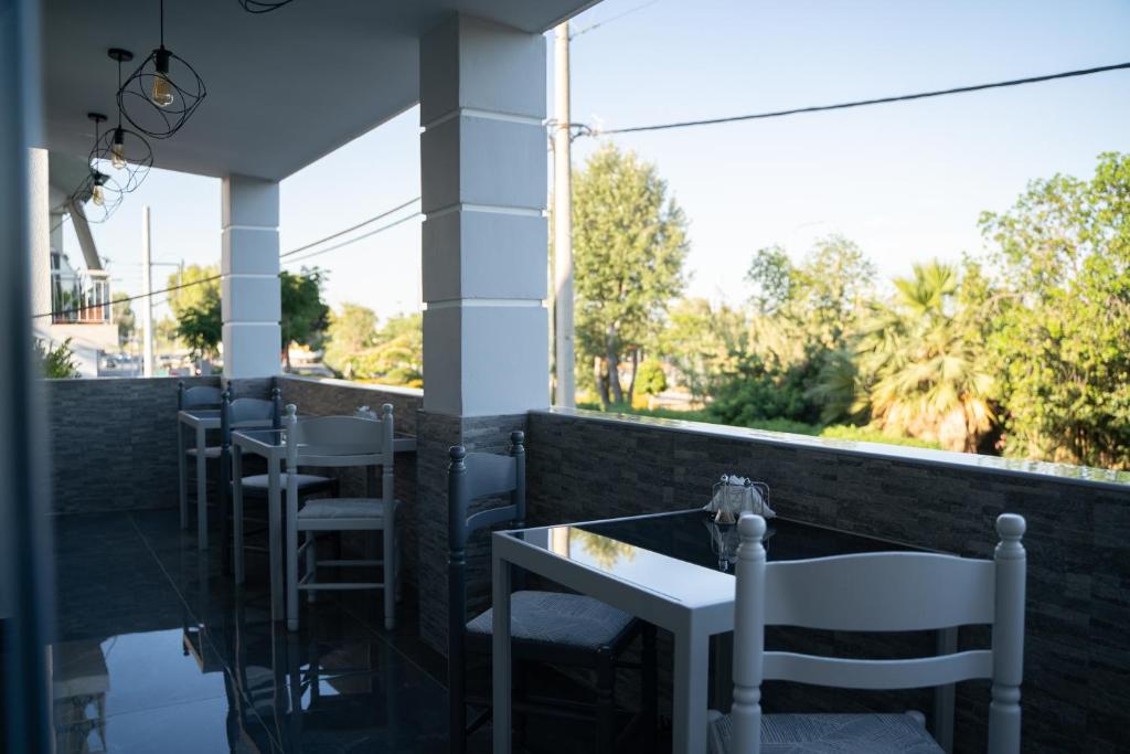 a row of tables and chairs on a balcony at Parthenis Riviera Hotel in Athens
