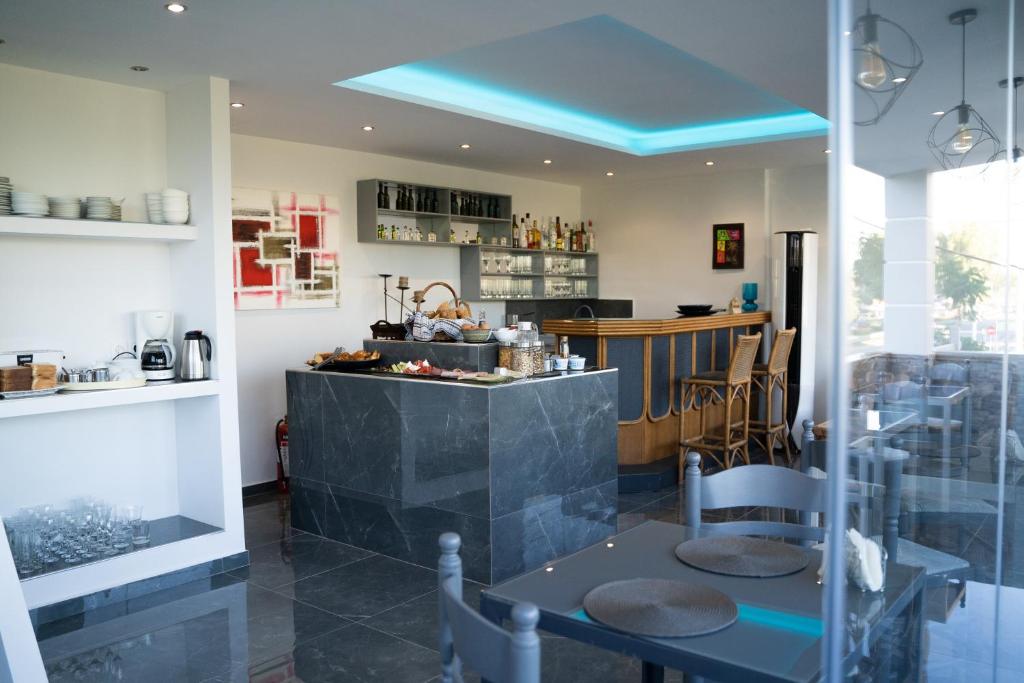 a restaurant with a bar with a blue ceiling at Parthenis Riviera Hotel in Athens