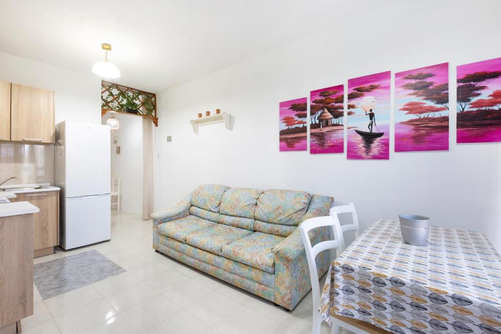 a living room with a couch and a table at NE1 - Lovely 2 bedroom apartment. Perfect location in Mellieħa