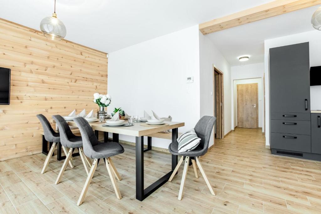 a dining room with a table and chairs at Apartmány Karlovy Dvory in Horní Planá