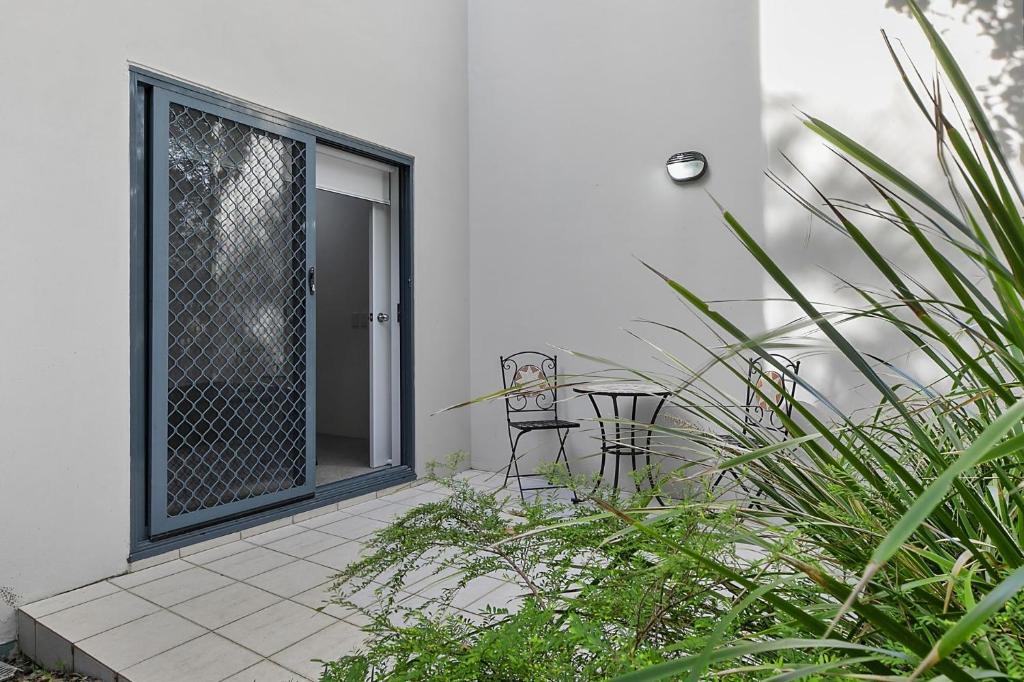 an open door to a patio with plants at Unit 3 21 Park Generous and Comfortable Beachside Abode in Sunshine Beach