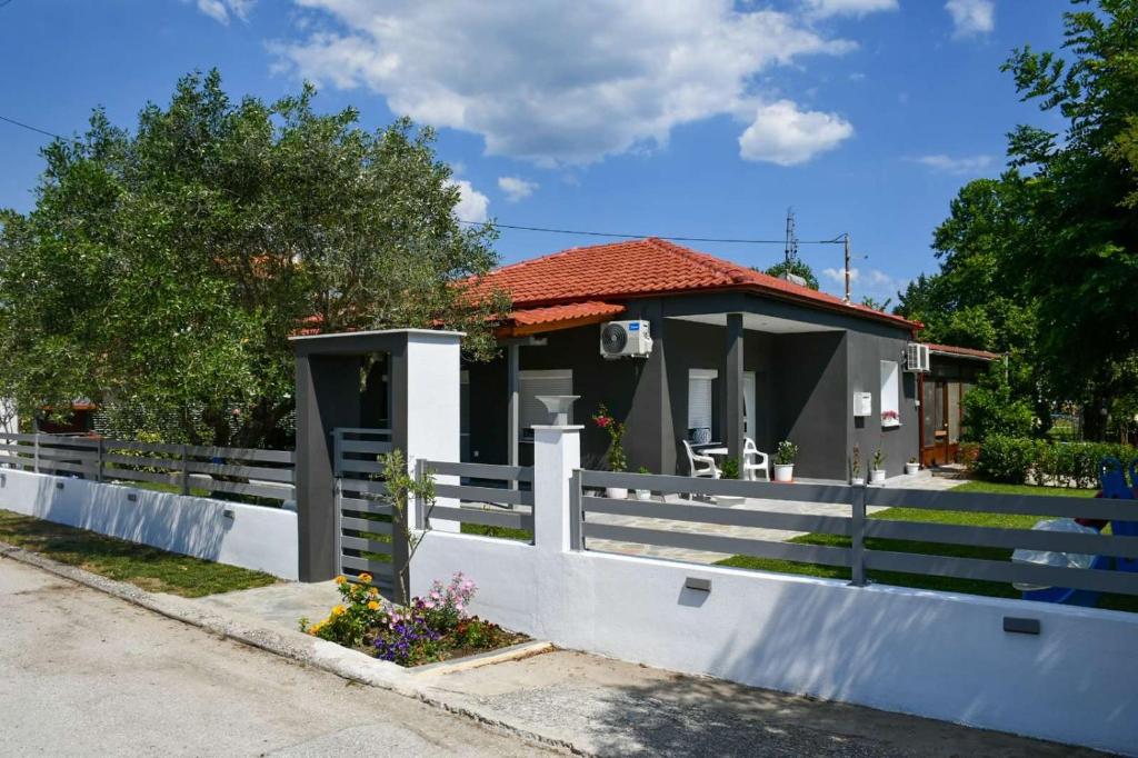 a house with a white fence in front of it at VILLA KOSTAS in Chaïdeftón