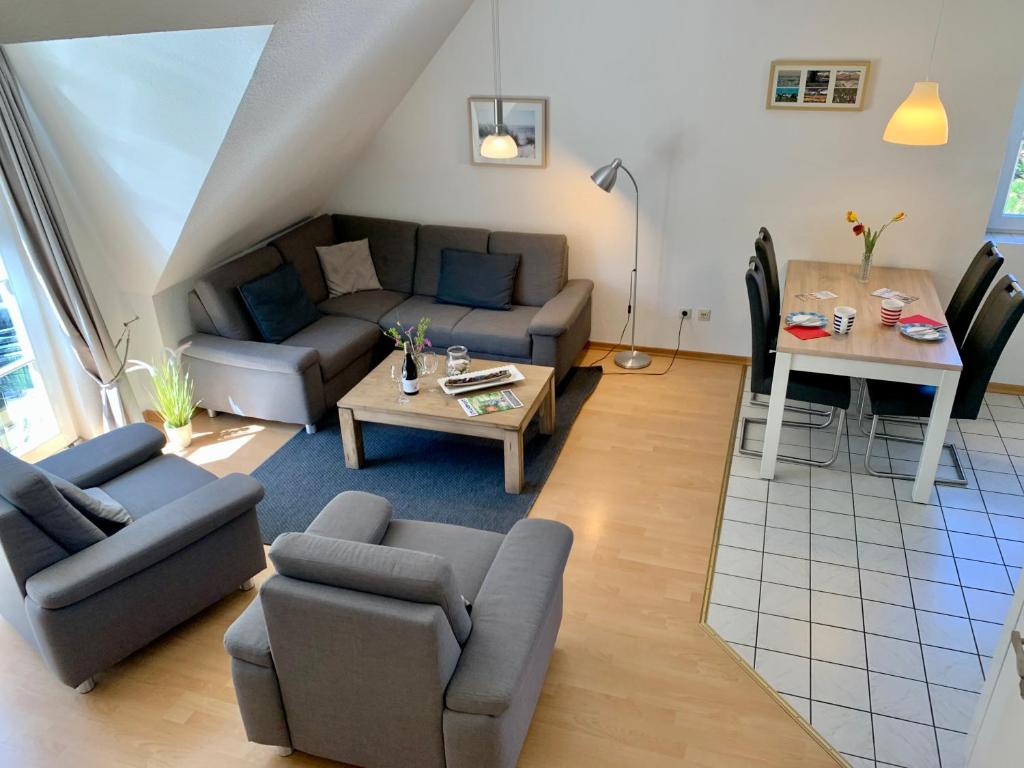 a living room with a couch and a table at Zum Leuchtturm - Ferienwohnung 3 in Sankt Peter-Ording