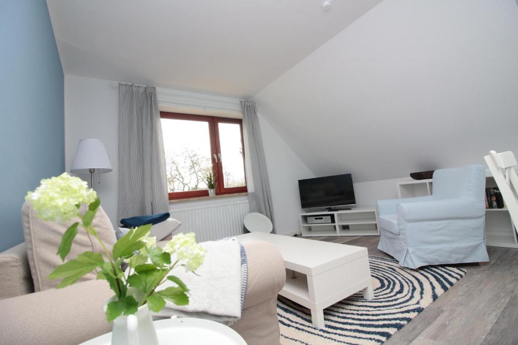 a living room with a couch and a table at Ferienwohnung 3 in der Waldstraße in Sankt Peter-Ording