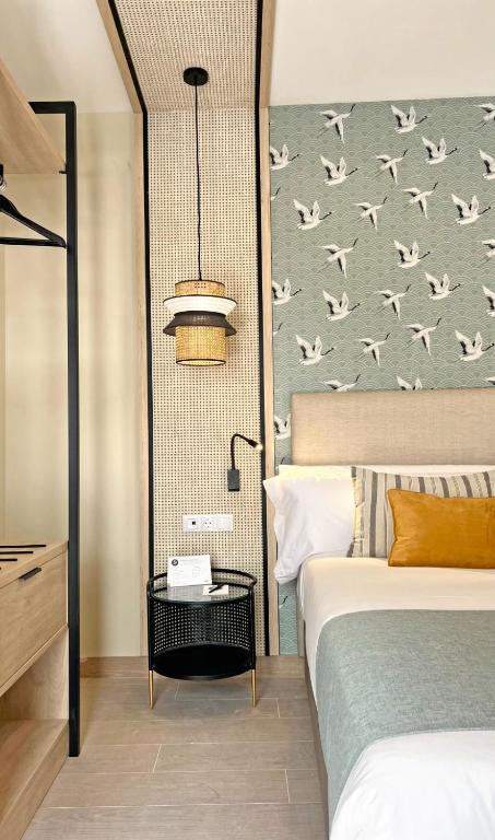 Postel nebo postele na pokoji v ubytování Soho Boutique Columela