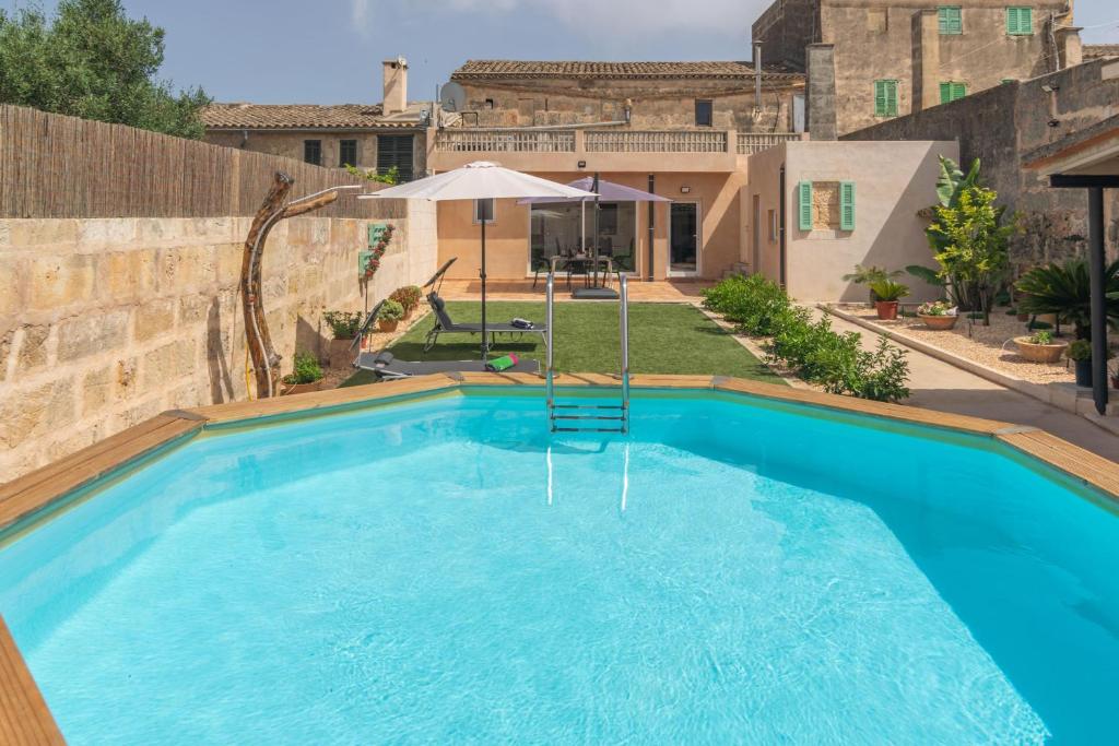 a swimming pool in the backyard of a house at Cas Padri Pep in Ariany