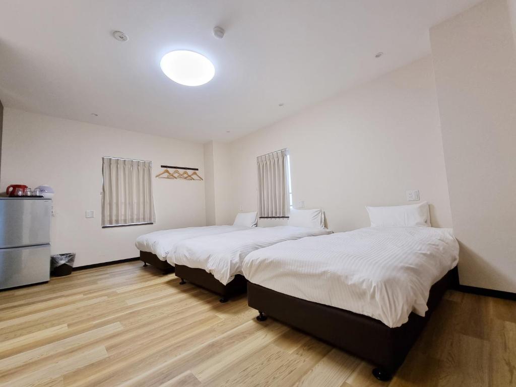 Posteľ alebo postele v izbe v ubytovaní KYU KYU HOTEL