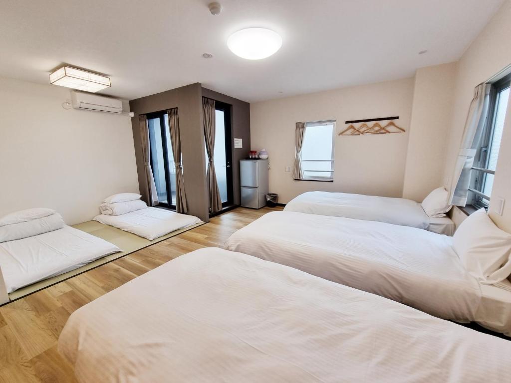 Posteľ alebo postele v izbe v ubytovaní KYU KYU HOTEL