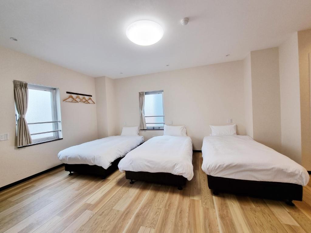Posteľ alebo postele v izbe v ubytovaní KYU KYU HOTEL
