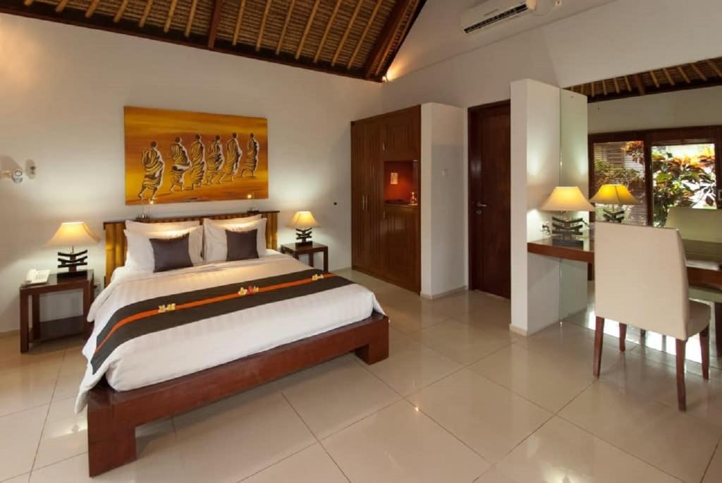 Postel nebo postele na pokoji v ubytování Siddhartha Oceanfront Resort & Spa Bali