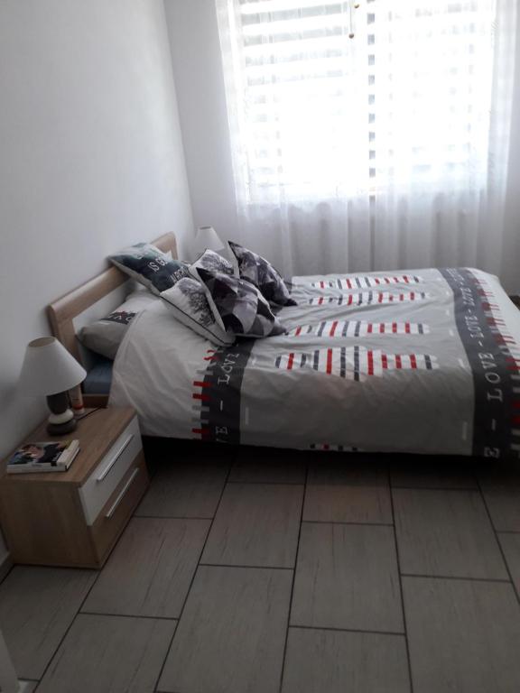 a bed sitting in a bedroom with a window at Sloneczny apartament w Giżycku in Giżycko