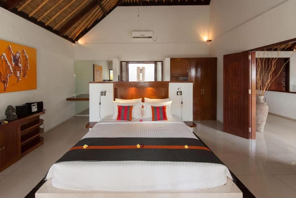 Postel nebo postele na pokoji v ubytování Siddhartha Oceanfront Resort & Spa Bali