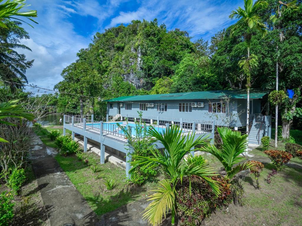 a house in the middle of a forest at Benarat Lodge in Mulu