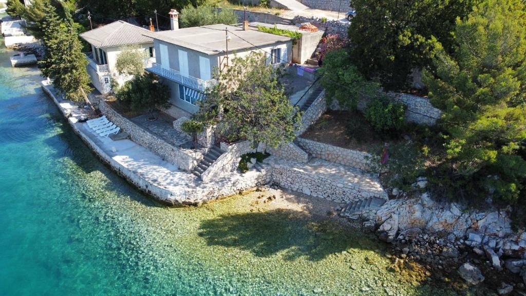 an aerial view of a house next to the water at Apartment Lisarica in Starigrad-Paklenica
