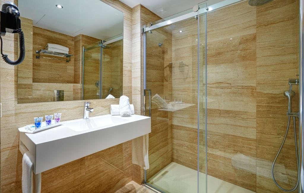 a bathroom with a sink and a shower at Grupotel Amapola in Playa de Muro
