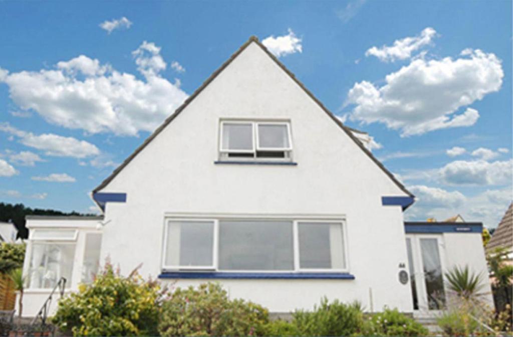 a white house with a gambrel roof at Spacious Detached House with Parking & Views in Fowey