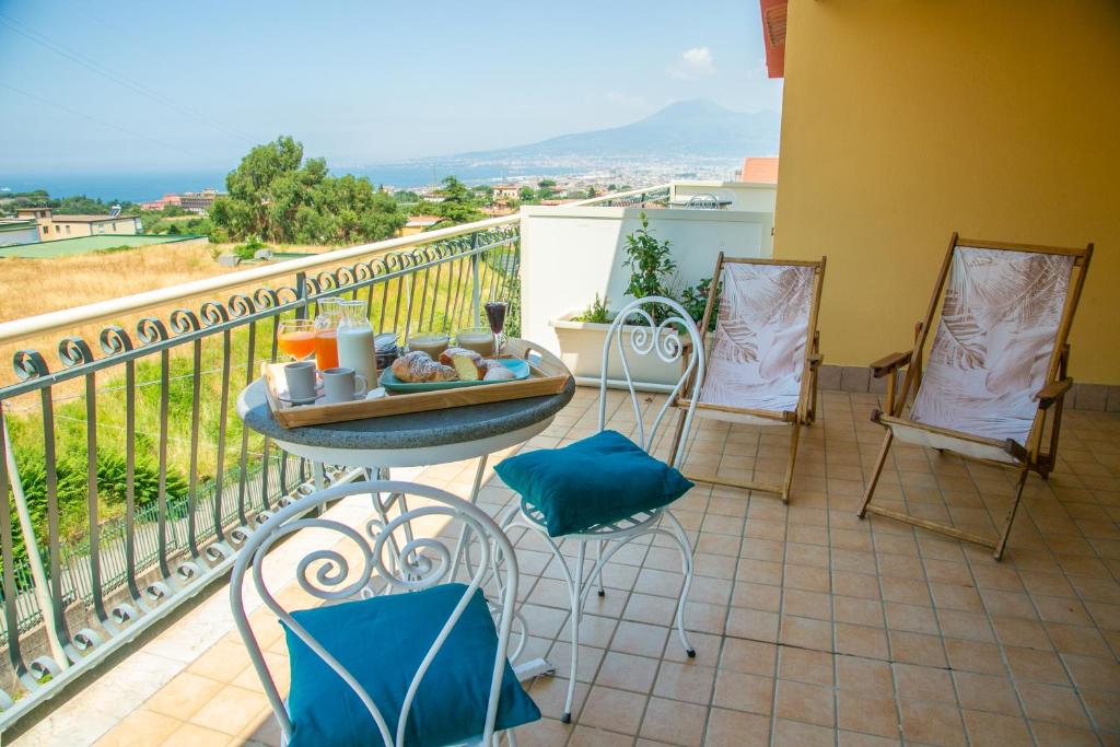 balcón con mesa, sillas y vistas en Perla Beach Stabia B&B, en Castellammare di Stabia