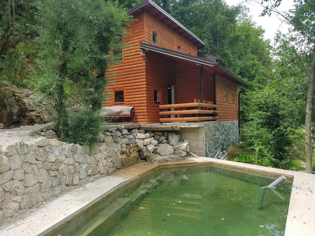 a house with a swimming pool in front of a house at Potok kuca sa bazenom in Konjic