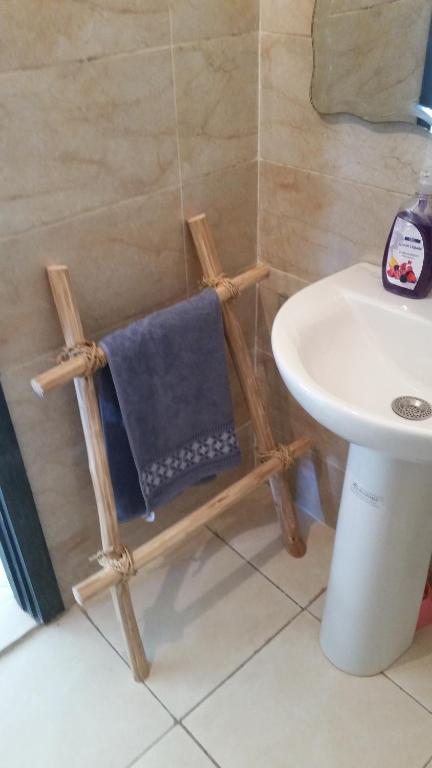 a bathroom with a wooden chair next to a sink at Ksiba in Salé