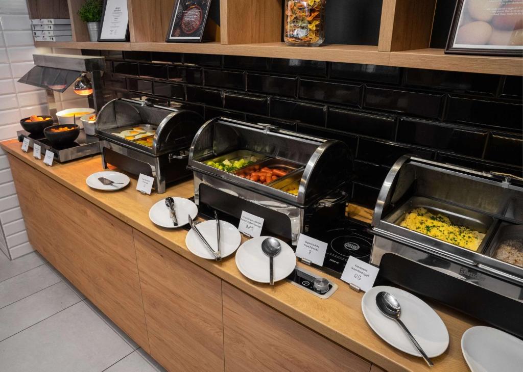 a buffet line with many different types of food at Park Inn by Radisson Vilnius Airport Hotel & Conference Centre in Vilnius