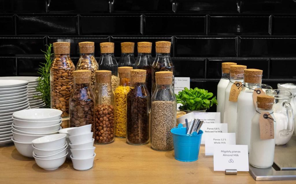 a table with many bottles of food and other items at Park Inn by Radisson Vilnius Airport Hotel & Conference Centre in Vilnius