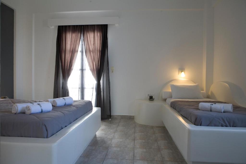 Postel nebo postele na pokoji v ubytování Philippion Boutique Hotel