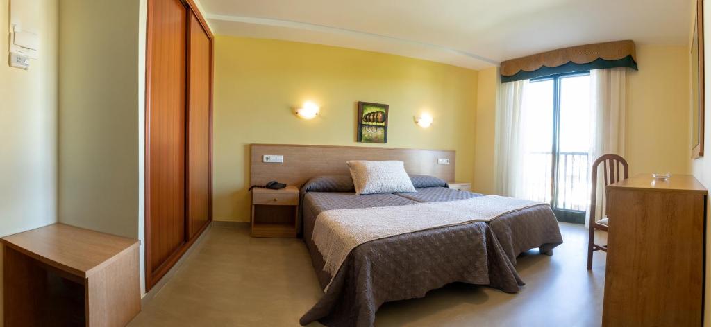 Postel nebo postele na pokoji v ubytování Hotel Veiganova