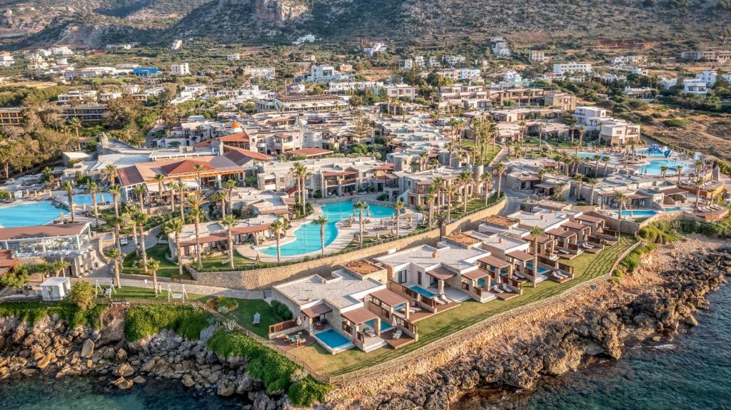 an aerial view of a villa with a resort at Ikaros Beach, Luxury Resort & Spa in Malia