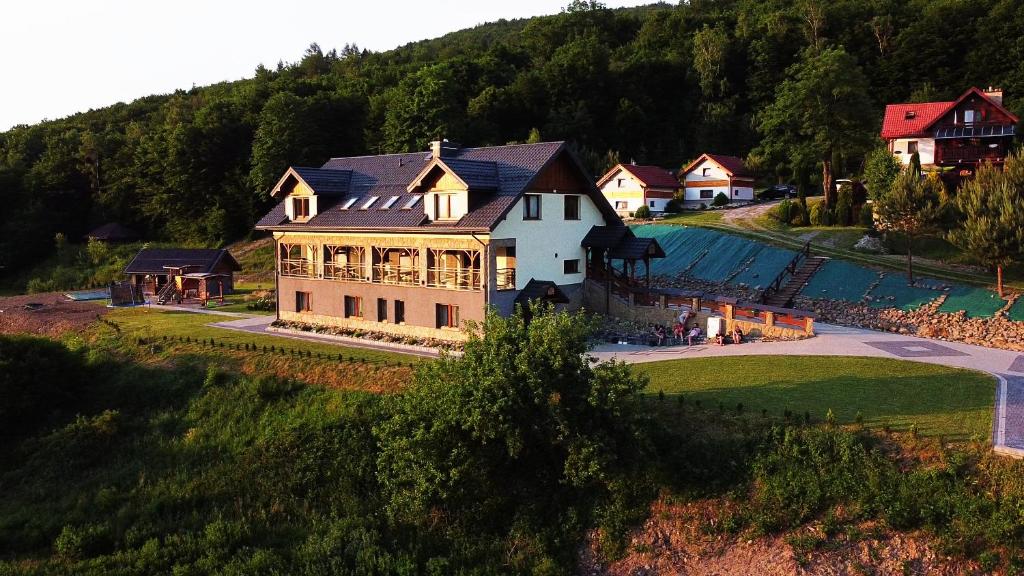 an aerial view of a large house on a hill at DobraNocka in Małastów