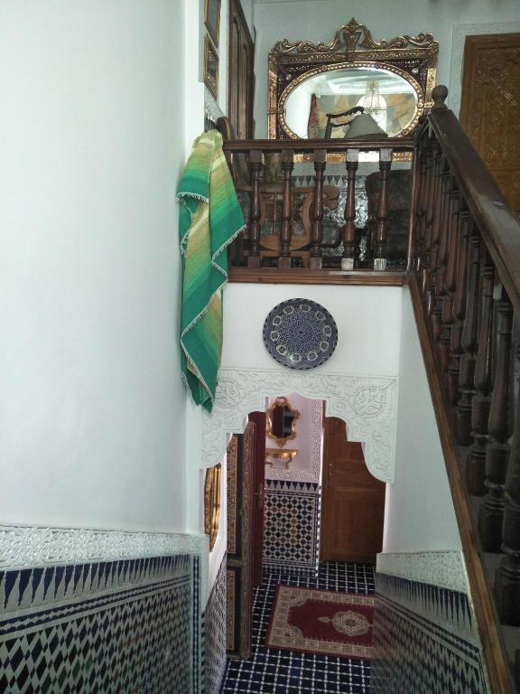 a staircase in a house with a mirror on the wall at Malabata Guest House in Tangier