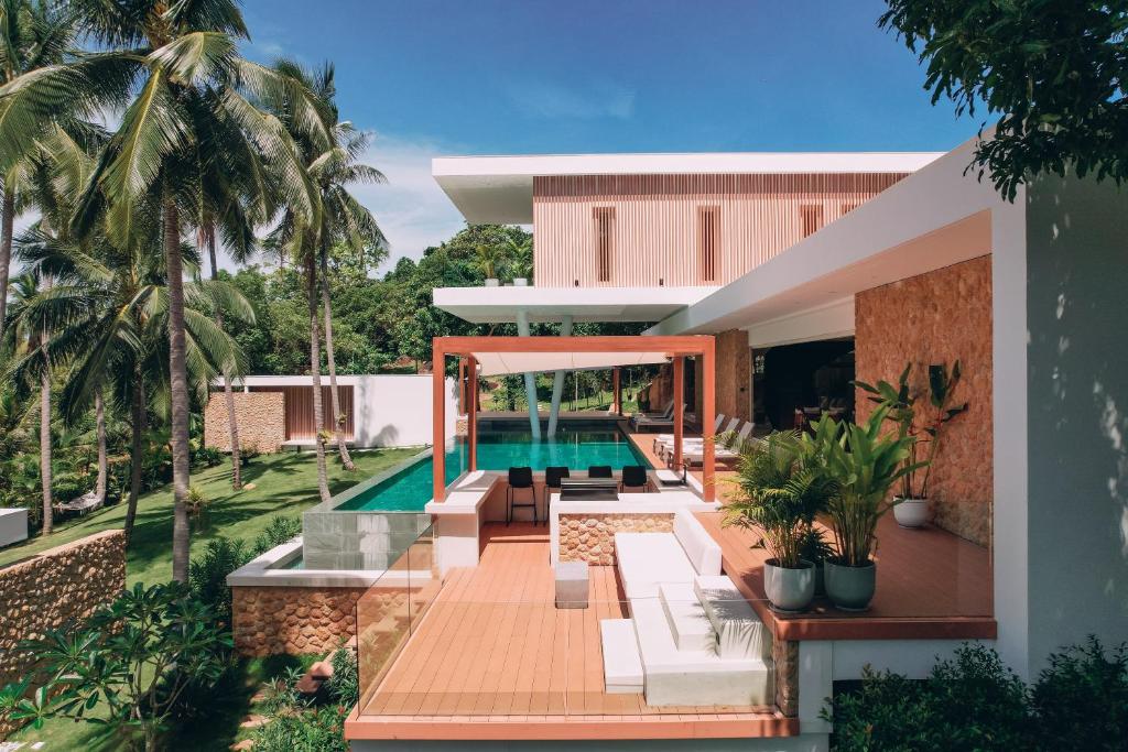 an external view of a house with a swimming pool at Anaia in Thongsala