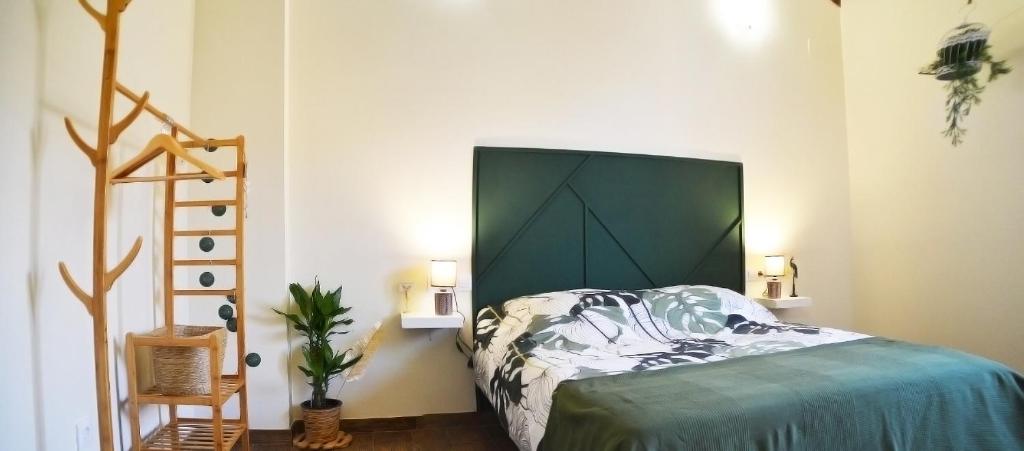 a bedroom with a bed with a large headboard at Casa Bienvenida - La Naturaleza in Carcagente