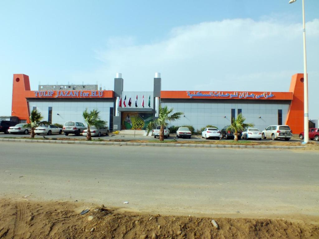 a store with cars parked in front of a street at Tulip Jazan in Jazan