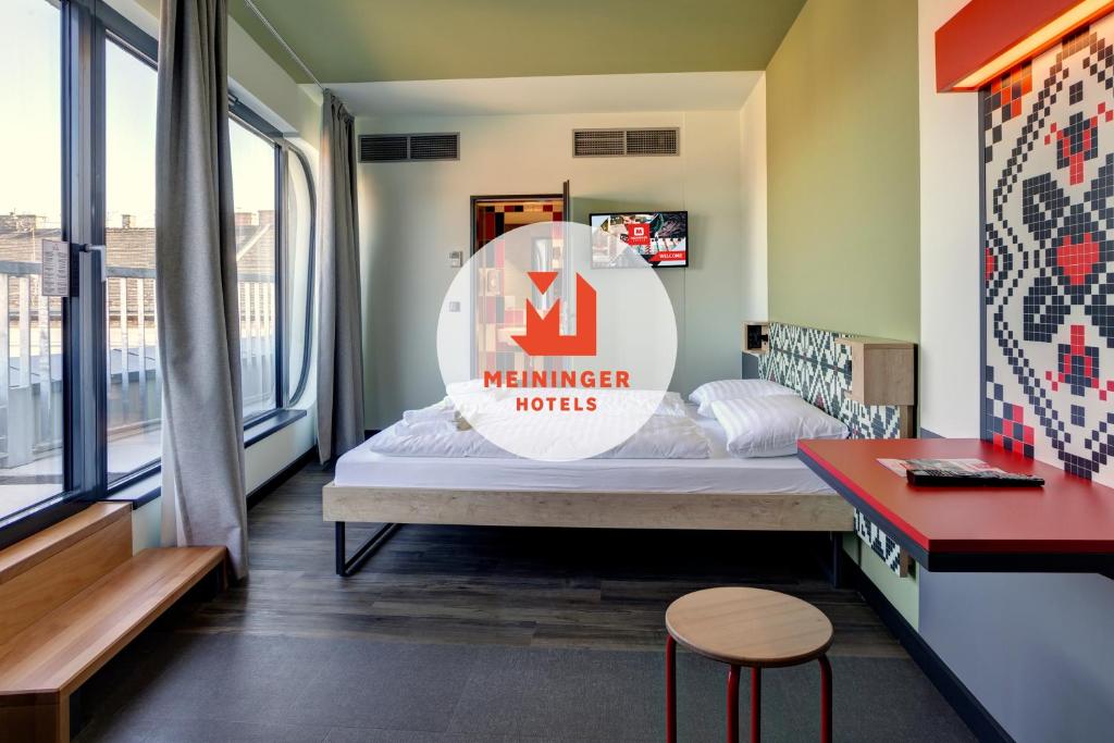 A bed or beds in a room at MEININGER Budapest Great Market Hall