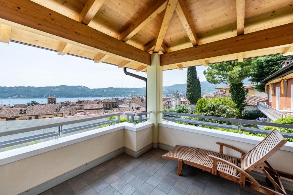 a balcony with a bench and a view of the city at Appartamento Rocchetta in Salò